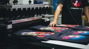 about - shirts laid out next to printer